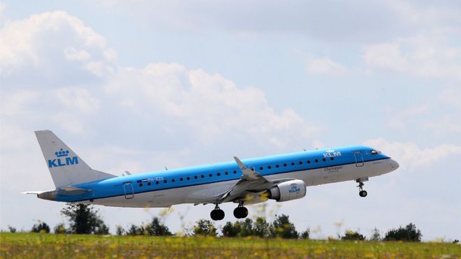 Image shows a KLM airlines plane taking off