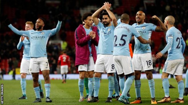 Manchester City players celebrate after their Derby win at Manchester United