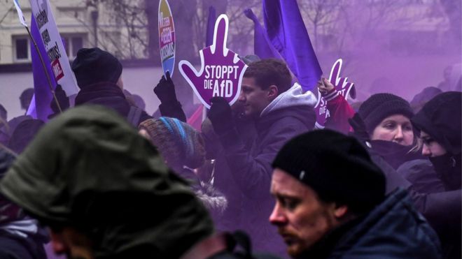 Protesters carry placards and shout slogans as they demonstrate during a protest against the convention of the German far-right populist Alternative for Germany party in Hanover, Germany, 2 December 2017