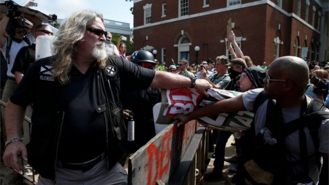 A white supremacist grabs a counter protesters