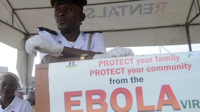 A health official waits to screen for the Ebola virus Muslim faithfuls on pilgrimage to Mecca on September 19, 2014 at the Murtala Mohammed International Airport in Lagos.