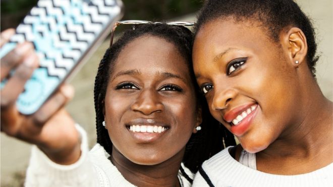 Two African teenage girls taking a selfie