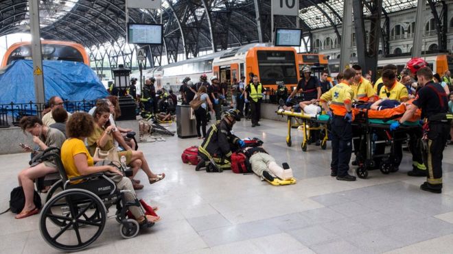 Spanish firefighters and paramedics treat injured people at Francia Railway Station in Barcelona, north-eastern Spain