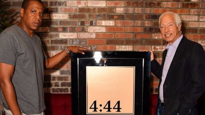 Jay-Z receives his platinum award from the RIAA