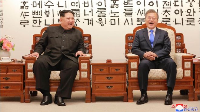 Kim Jong-un (L) talking with South Korea's President Moon Jae-in (R) before the inter-Korean summit at the Peace House building on the southern side of the truce village of Panmunjom on 27 April (picture released by North Korean state media)