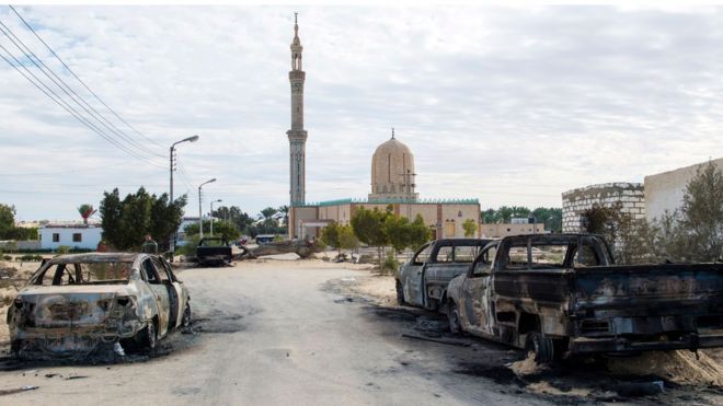 Burnt-out cars in the aftermath of the attack on Rawda mosque, 25 November 2017