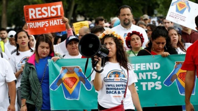 Demonstrators carrying signs march during a rally by immigration activists CASA and United We Dream demanding the Trump administration protect the Deferred Action for Childhood Arrivals (DACA) program and the Temporary Protection Status (TPS) programs, in Washington, U.S., August 15, 2017.