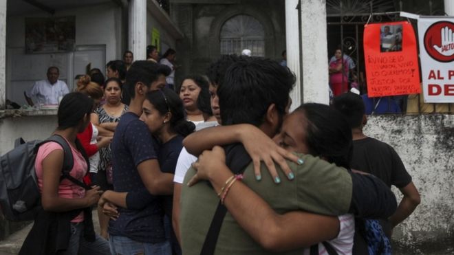 Residents embrace to celebrate that Rev. Jose Luis Sanchez Ruiz has been found alive, at a his church in Catemaco, Veracruz state, Mexico, Sunday, Nov. 13, 2016