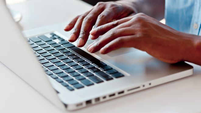 Man typing on macbook