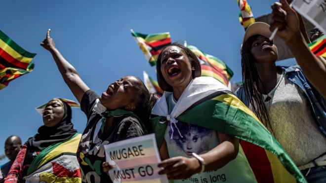 This file photo taken on November 18, 2017 shows supporters of Tajamuka Sesijikisile SA, The African Democrats Opposition Party, the Zimbabwe Communist Party, the Zimbabwe Diaspora Coalition and other groups attending a rally at the Union Buildings in Pretoria, South Africa, to call for the resignation of Zimbabwe"s President.