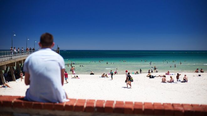 People enjoy Adelaide's Glenelg beach amid a heatwave earlier this month