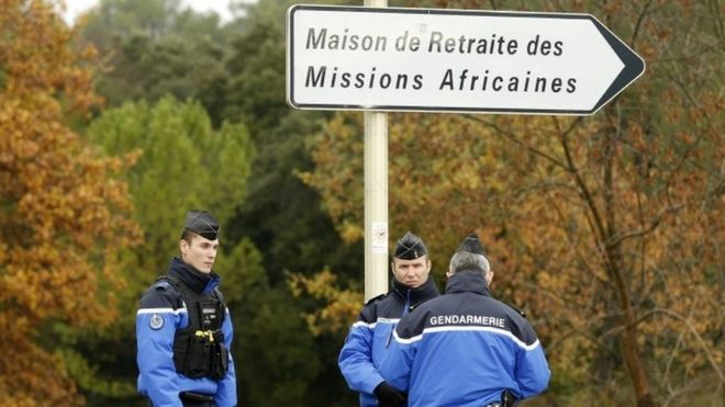Police stand guard along a security area near a retirement home for Catholic missionaries in Montferrier-sur-Lez