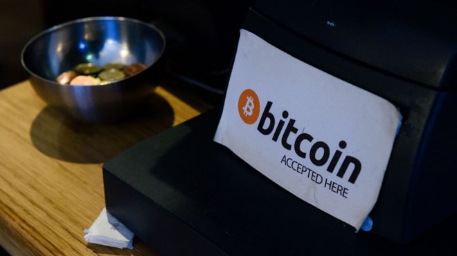 A coffee shop sign advertises that the digital currency 'Bitcoin' is accepted in central Dublin