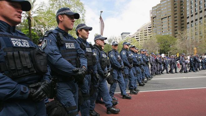 Australian Federal Police officers line up near a protest in 2007