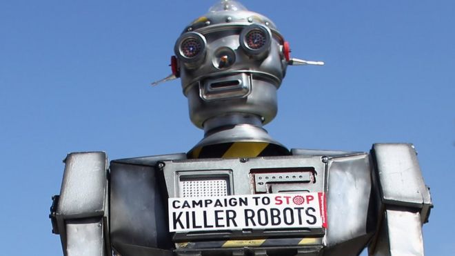 A robot distributes promotional literature calling for a ban on fully autonomous weapons in Parliament Square, London, 23 April 2013