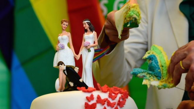 Green party deputies cut a wedding cake in rainbow colours and decorated with figurines of two women and two men in their office at the Bundestag (lower house of parliament) after it voted to legalise same-sex marriage on 30 June 2017