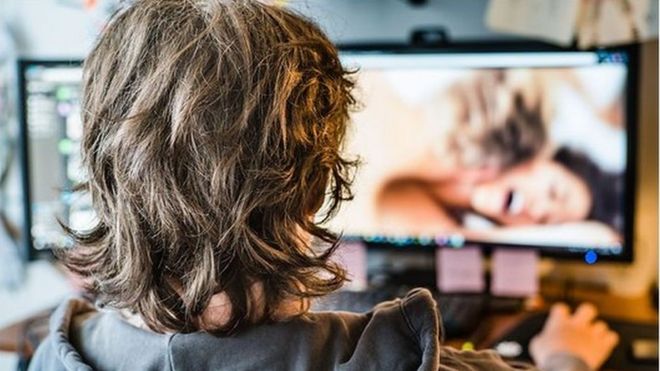Young man looks at pornography on computer