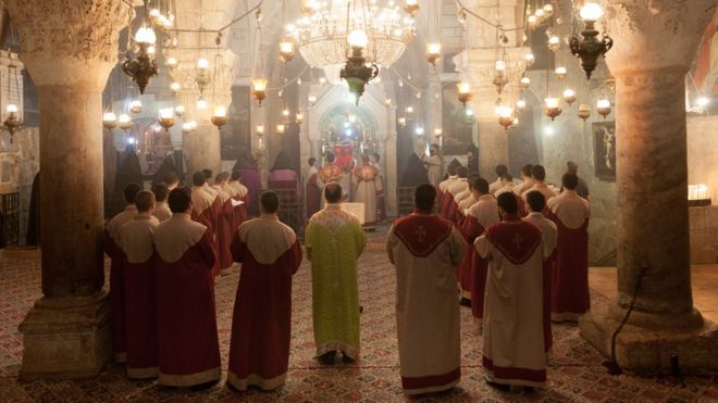 priests inside Church of the Holy Sepulchre