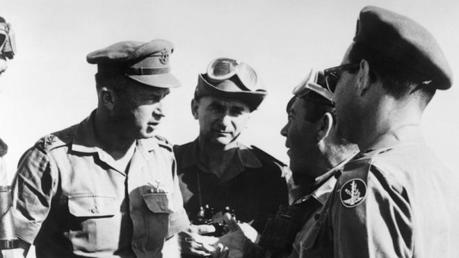 Israeli army chief of staff Yitzhak Rabin (L) confers with his officers during military manoeuvres in the Neguev in May 1967