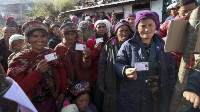 People show their voter ID cards before casting ballots in Rashuwa district, Nepal. Photo: 26 November 2017