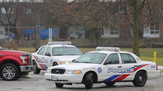 Toronto police cars pictured outside the girl's school