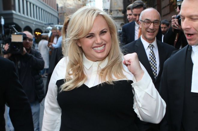 Rebel Wilson celebrates as she leaves court in Melbourne, Australia.