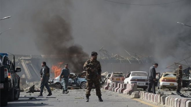 An Afghan security force member stands at the site of a car bomb attack in Kabul on May 31, 2017.