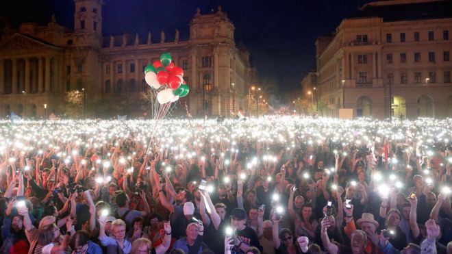 People attend a protest against the government of Prime Minister Viktor Orban in Budapest, 14 April 2018