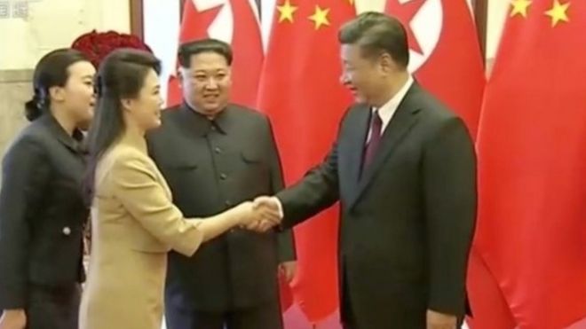 Kim Jong-un's wife Ri Sol-ju shakes hands with Xi Jinping