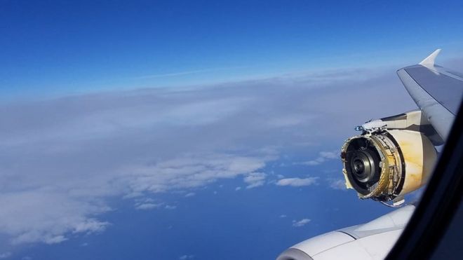 A photo shows the view form a plane in mid-air, with a severely damaged engine clearly visible, with parts missing and substantial metal damage