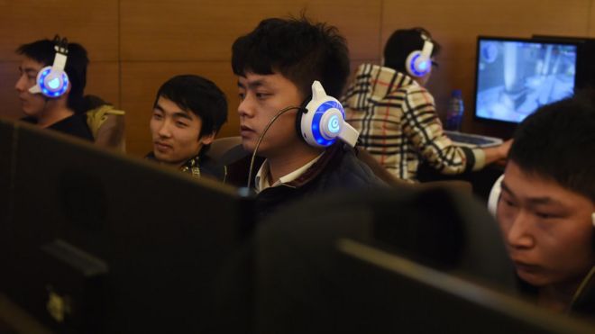 Men using computers in Beijing internet cafe, December 2015