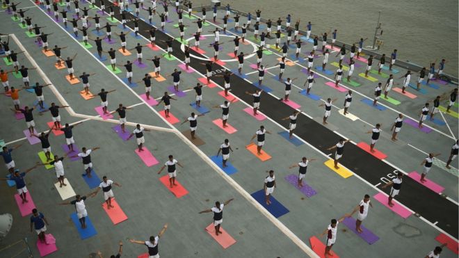 Indian Armed Forces personnel take part in a yoga session to mark International Yoga Day on the Indian Navy aircraft carrier INS Viraat anchored at the Mumbai harbour on June 21, 2017.