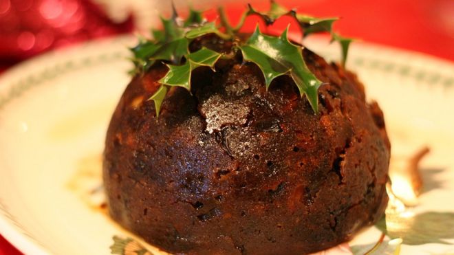 A traditional Christmas Pudding with holly decoration