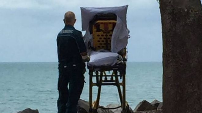 Woman and paramedic at beach