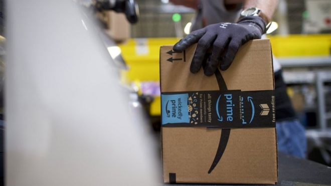 A worker boxes orders at the Amazon Fulfillment Center on August 1, 2017 in Robbinsville, New Jersey.