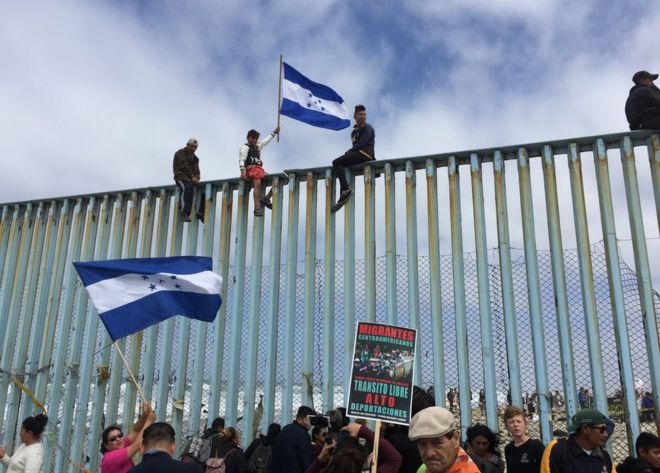Protesters gather at the US-Mexico border fence at a beach in Tijuana, Mexico, 29 April 2018