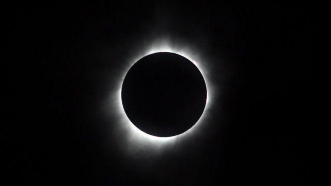 Thesun is seen in full eclipse over a park on August 21, 2017 in Hiawatha, Kansas