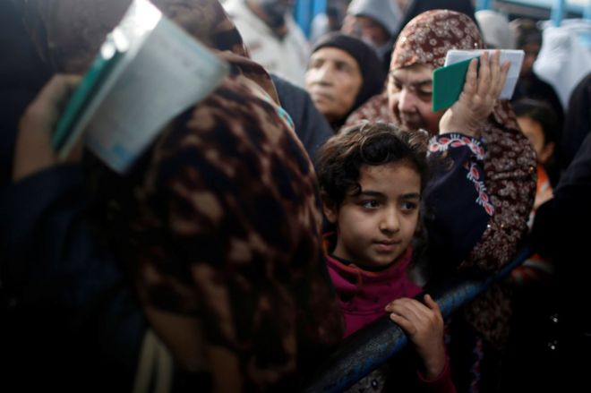 Palestinian refugees wait to receive aid at a United Nations food distribution centre in Al-Shati refugee camp in Gaza City January 15, 2018