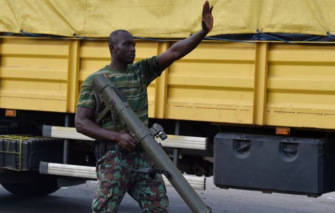 A mutinous soldier patrols in the streets of Ivory Coast's central second city Bouake, in May 14, 2017