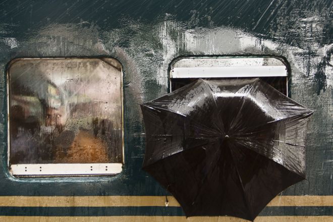 A man looks out from a train at Tongi Railway Station, Gazipur, Bangladesh