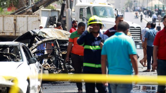 A wreckage of a car is seen at the site of car bomb attack near a government office in Karkh, Baghdad, Iraq (30 May 2017)