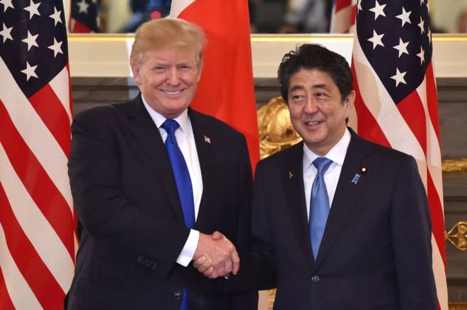 US President Donald Trump (L) shakes hands with Japanese Prime Minister Shinzo Abe (R) before a summit meeting at Akasaka Palace in Tokyo on 6 November 2017.