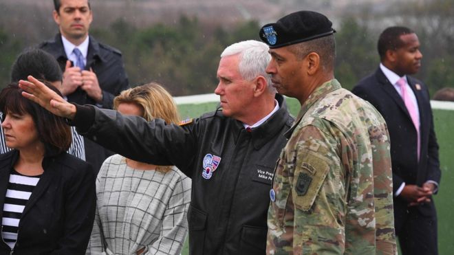 US Vice President Mike Pence (C) talks with US General Vincent K. Brooks (R), commander of the United Nations Command, Combined Forces Command and United States Forces Korea, as they visit Observation Post Ouellette near the truce village of Panmunjom in the Demilitarized Zone (DMZ) on the border between North and South Korea on 17 April 2017.