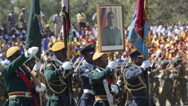 Zimbabwean troops holding a portrait of President Robert Mugabe parade in Harare, on April 18, 2008 during celebrations marking the country's 28th anniversary of independence