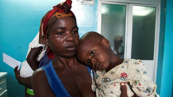 A mother holds her child suffering from yellow fever at a hospital in Luanda, Angola, March 15, 2016