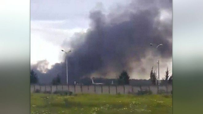 Smoke over fields after a military plane crash in Boufarik, Algeria
