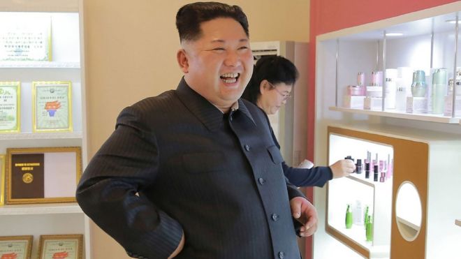 North Korean leader Kim Jong-un smiles as he visits a cosmetics factory