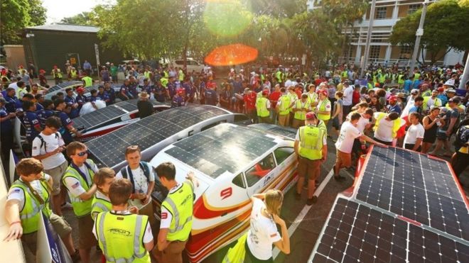 Team members gather around cars as they prepare for the start of the race in Darwin, Australia. Photo: 8 October 2017