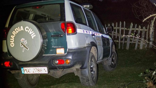 A patrol car of Spanish Guardia Civil is parked in La Roza rural area, near Cangas de Onis, where a helicopter that was battling a fire crashed on December 23, 2015