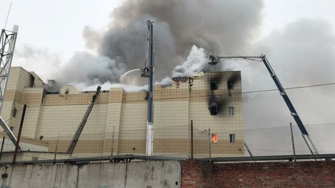 Firefighters extinguish a fire at a shopping mall in Kemerovo, Russia March 25, 2018